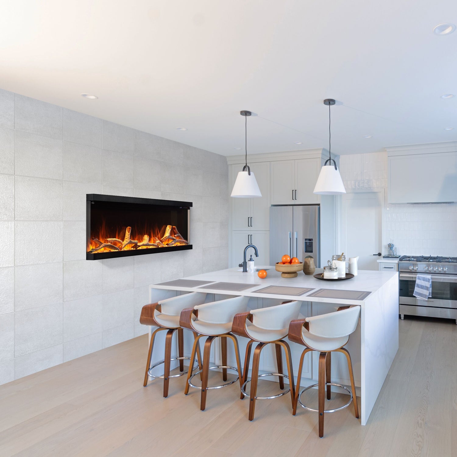 Modern kitchen with white countertops, wooden stools, and a fireplace.