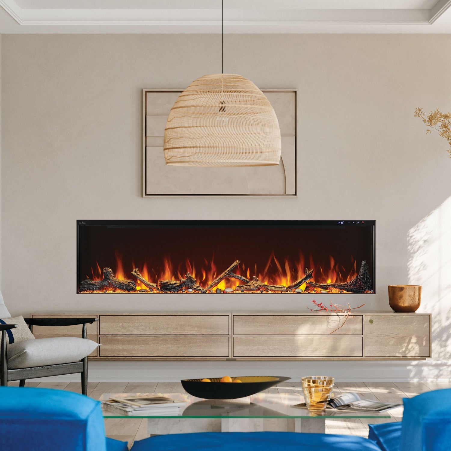 Modern living room with a large electric fireplace, blue sofas, and decorative elements.