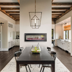 Modern dining room with a fireplace and wooden ceiling beams.