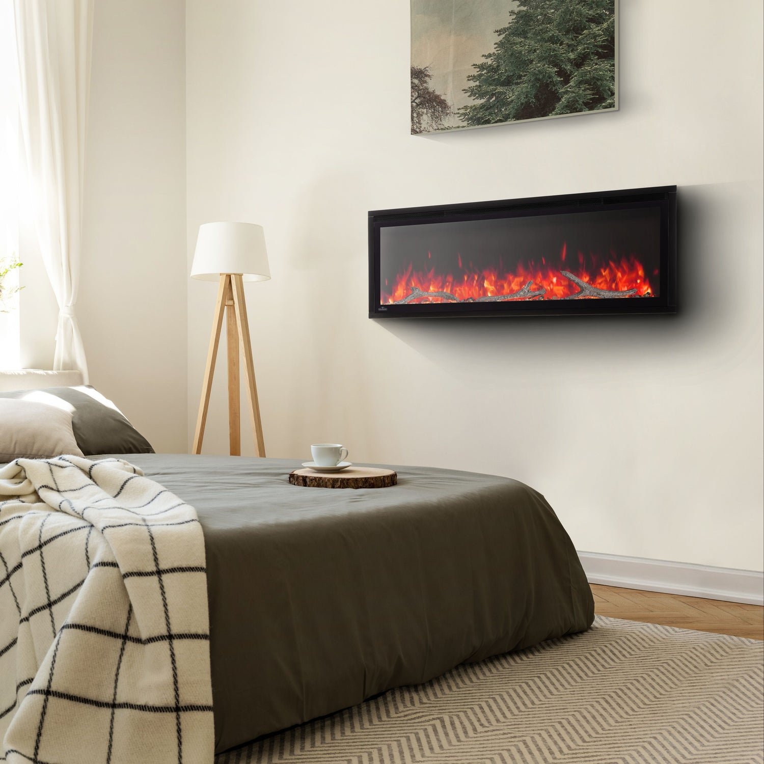 Bedroom with a wall-mounted electric fireplace and a bed with a blanket.